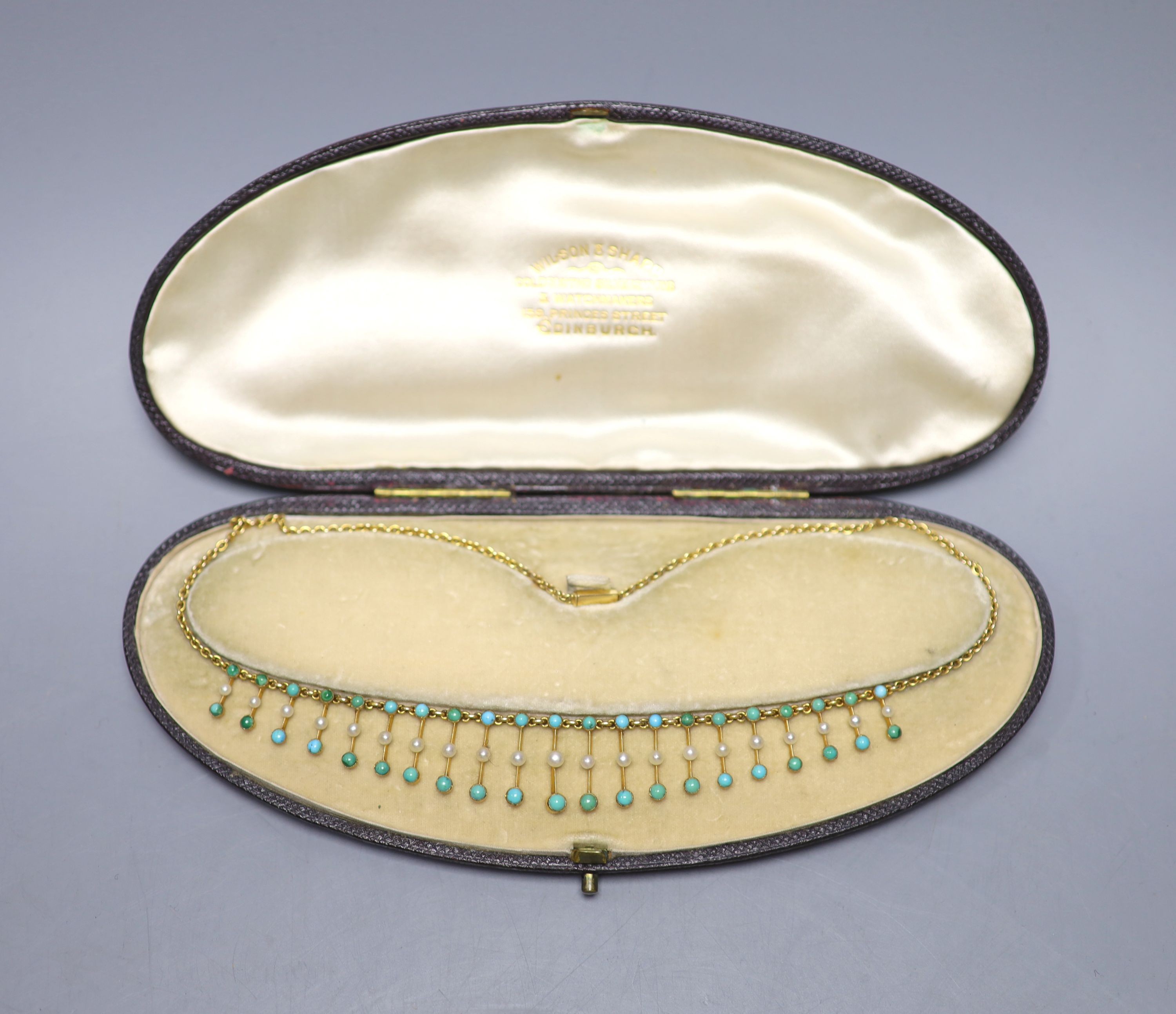 An Edwardian yellow metal, seed pearl and turquoise set fringe necklace, 42cm, gross weight 15.2 grams.
